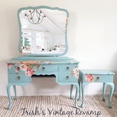 a blue dresser with flowers painted on it and a mirror over the top that says fish's vintage revival