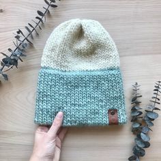 "Double brim hand knit hat Material: 100% Wool Roving Attached vegan leather tag with Canvas & Wool Co logo Size: Adult: 21\"-23\" This double brim hat will keep you cozy and warm all winter long. The 100% wool roving yarn is thick, soft and not itchy. This hat is made to fit not too tight and not too loose. Hats are offered with and without pompoms.  To buy a hat without a pompom: Enter n/a in the personalization box. To buy a hat with a pompom: Select \"With Faux Fur Pompom\" and add the pompo Double Brim Knit Hat, Roving Yarn, Co Logo, Wool Roving, Hand Knit Hat, Leather Tag, Brim Hat, Knit Hat, Star Fashion