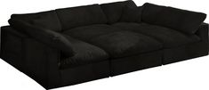 a black couch sitting on top of a white floor