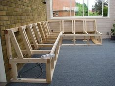 a wooden bench sitting in front of a window on top of a carpeted floor