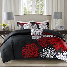 black and red bedding with white flowers on it