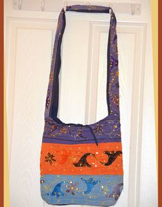 Untitled Document embroidered green shoulder bag hand bag purse from India        Home    Items On Sale  Pillow Covers  |  Wall Tapestries   |   Jewelry Boxes  |     Hand bags  |  Miniature Paintings  |   Keychain Holders  |    Journals         HAND EMBROIDERED  SEQUIN SLING BAG/SHOULDER BAG         Measurement: 13"H x 12"W x 20"(strap drop) This cotton bag is done using blue, orange purpler. Embroidery is done using sequins, gold thread and silk threads.  This bag has tie closure at the top and Blue Embroidered Bag As A Gift, Embroidered Blue Rectangular Shoulder Bag, Rectangular Blue Embroidered Shoulder Bag, Blue Shoulder Bag For Gift, Embroidered Blue Crossbody Bag, Blue Embroidered Crossbody Bag, Blue Cotton Shoulder Bag As Gift, College Bags, Box Hand