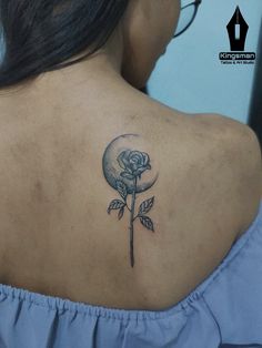 a woman with a rose tattoo on her upper back shoulder and the moon behind it