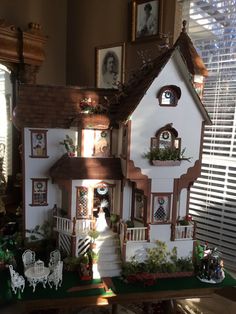 a doll house is shown in front of a window