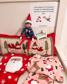 an elf is sitting on top of the bed with his christmas pajamas and pillowcase