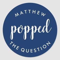 a blue sticker that says,'mathew popped the question '