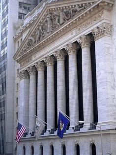 an old building with columns and flags on the front in new york city, ny