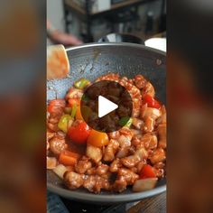 a pan filled with meat and vegetables on top of a stove