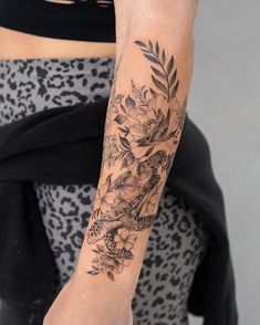 a woman with a flower tattoo on her arm