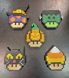 four perler beads are arranged in the shape of an owl, pumpkin, and cat