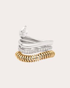 Sculpted from a continuously coiled line, this 18-karat white gold ring is comprised of three unique bands—one polished, one decorated with diamonds and one encircled with yellow gold hoops. A single pear-cut diamond balances along the top edge to create a floating effect. From Rainbow K’s Versus Collection, intemporal creations that reveal natural beauty. 18k white gold, 18k yellow gold and white diamond Diamond carat: 0.47 ctw Diamond color: F Diamond clarity: VS Diamond cut: round, pear Polis White Gold Jewelry With Brilliant Cut In Spiral Shape, Spiral Yellow Gold Diamond Ring, White Gold Spiral Jewelry With Brilliant Cut, Spiral White Gold Jewelry With Brilliant Cut, Luxury Diamond Spiral Ring, Modern Twist White Gold Spiral Rings, Modern Twist White Gold Ring With Single Diamond, White Gold Double Band Ring Fine Jewelry, Fine Jewelry Diamond Spiral Ring