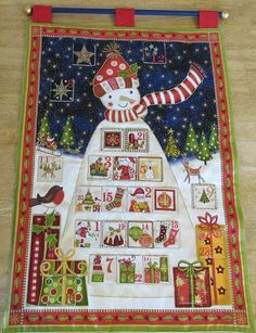 a quilted christmas tree with a snowman on top and presents in the bottom