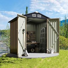 an outhouse with its door open on the grass