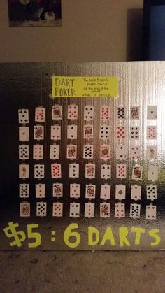 a large metal board with lots of playing cards on it's sides and the words 5 - 6 darts written in yellow