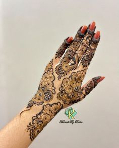 a woman's hand with henna on it