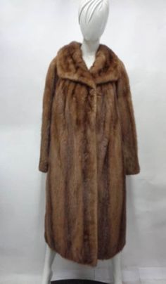 DESCRIPTION:   BEAUTIFUL & VERY STYLISH NATURAL CANADIAN PASTEL MINK FUR COAT FOR WOMEN, MADE FROM FULLY LET OUT SKINS, THE BEST!  THE COLLAR TYPE IS "SHAWL", IT CLOSES WITH HOOK & EYE CLOSURES AND HAS TWO SIDE POCKETS. THIS ITEM IS PRE-OWNED: THE FUR IS "EXCELLENT" THE BEST CONDITION AND THE INSIDE LINING IS "MINT", THE SECOND BEST! AFTER BUYING THIS ITEM, IT WOULD BE VERY MUCH APPRECIATED IF YOU COULD PROVIDE YOUR HEIGHT, WEIGHT AND BUST CIRCUMFERENCE, SO WE CAN ADJUST THE COAT TO YOUR SIZE, BEFORE SHIPPING, IF NEEDED. IT WILL ALSO HELP US TO SHIP YOUR ITEM SOONER, THANK YOU! :) MEASUREMENTS:   *SIZE: 12 LARGE *LENGTH: 49"  *SLEEVES: 30" LONG LENGTH; MEASURED FROM THE SIDE OF THE NECK TO 2" BELOW YOUR WRIST, WITH YOUR ARM SIDE TO YOUR BODY WHY YOU SHOULD BUY YOUR PRE-OWNED FURS ONLY FROM Classic Formal Fur Coat For Fall, Classic Mink-colored Formal Outerwear, Classic Mink Color Formal Outerwear, Classic Fall Fur Coat, Classic Long Sleeve Fur Coat For Fall, Classic Fitted Long Sleeve Fur Coat, Formal Long Sleeve Mink Outerwear, Vintage Long Sleeve Mink Outerwear, Classic Long Sleeve Mink Outerwear