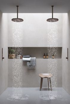 a bathroom with rain coming from the shower head