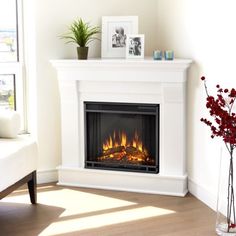 a white fireplace with a fire in it