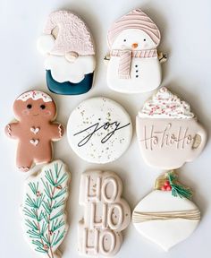 decorated cookies are arranged on a white surface