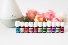 an assortment of essential oils sitting next to flowers