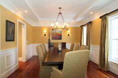 a dinning room table with chairs and a chandelier