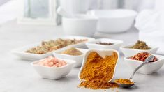 several bowls filled with different types of spices