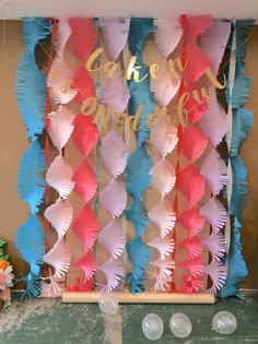 there is a cake and cupcake display on the table with pink, blue, and white feathers