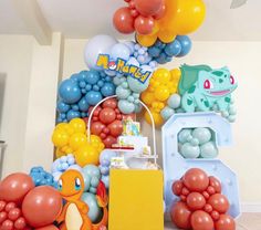 an assortment of balloons and decorations for a pokemon birthday party