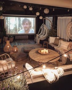 a living room filled with furniture and a flat screen tv mounted to the side of a wall