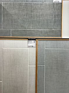 two gray tile backsplashes with wood trims on each side and one in the middle