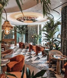 the interior of a restaurant with checkered flooring and potted plants