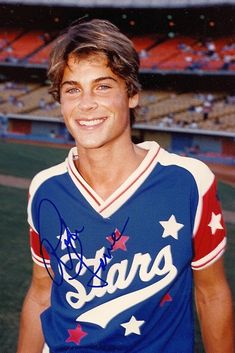 an autographed photograph of a baseball player in uniform at a game with fans