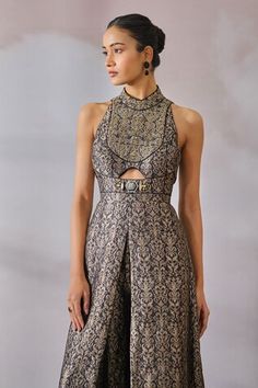 Black brocade jumpsuit with silver floral woven patterns, embroidered yoke, TT embellished brooch, front and back cutout. - Aza Fashions Saree To Jumpsuit, Banarasi Jumpsuit, Brocade Dress Indian, Banarasi Outfits, Brocade Outfits, Brocade Dress Styles, Saree Upcycle, Brocade Jumpsuit, Indian Jumpsuit