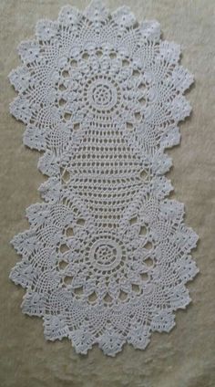 a white doily is laying on top of a table