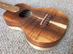 a small ukulele sitting on the floor