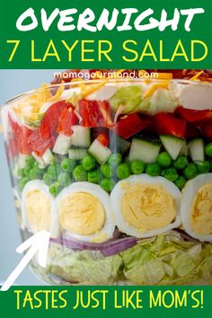 a layered salad with hard boiled eggs and vegetables in it is featured for the seven layer salad