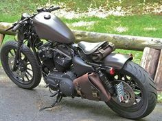 a motorcycle parked next to a wooden fence