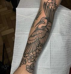 a person with a bird tattoo on their arm