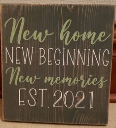 a wooden sign that says new home beginning new memories est 2021