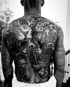 a man with many tattoos on his back