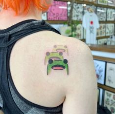 a woman with a green car tattoo on her back shoulder