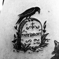 a black and white photo of a tattoo with a bird on it