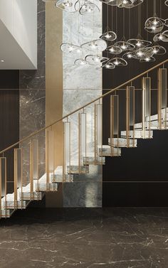 an elegant staircase with chandeliers and marble walls