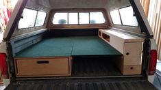 the back end of an old van with drawers and desks in it's cargo area