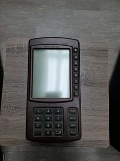 a cell phone sitting on top of a wooden table