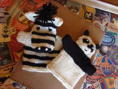 two knitted animal hats sitting on top of a cardboard box