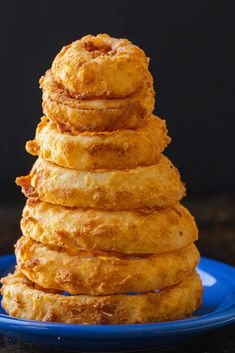 a stack of doughnuts sitting on top of a blue plate