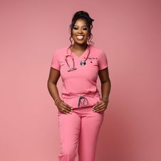 a woman in pink scrubs posing for the camera