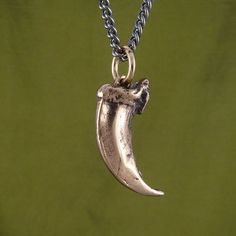 "Our Wolf Claw necklace in bronze. ★Here's the claw in Sterling silver - https://www.etsy.com/ca/listing/970531463★ Cast in solid bronze from a museum-quality Arctic Wolf claw replica. The wolf claw measures 1 1/4\" from the top of the knuckle to the tip, and every tiny detail of the original claw is replicated. Like all Lost Apostle jewelry, this wolf claw is cast in the finest jewelers bronze and polished and finished entirely by hand. A patina is applied to the piece to really bring out the s Arctic Wolf, Claw Necklace, The Claw, Fine Jewels, The Wolf, Dog Tag Necklace, Pendant Necklaces, Patina, Necklaces