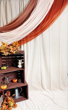 a wooden shelf filled with lots of fall decorations